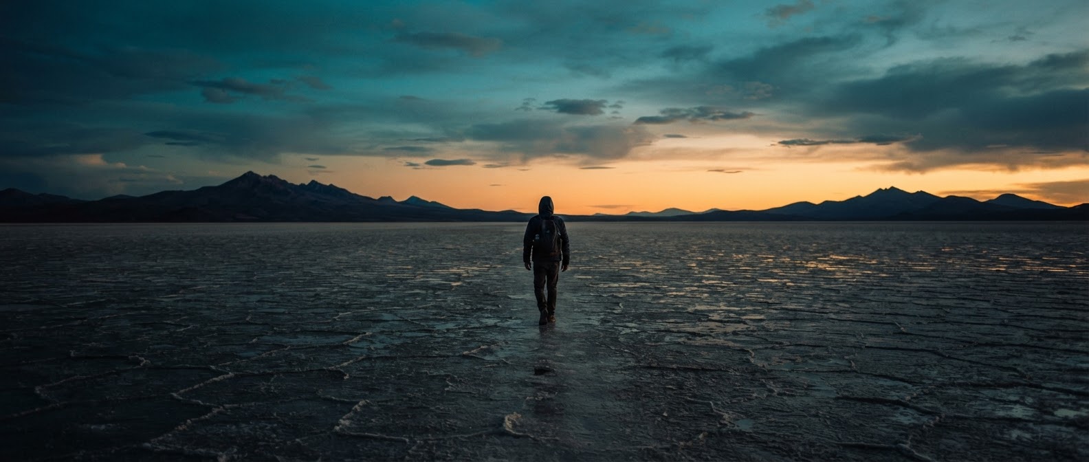 Cinematic dusk landscape with a figure on a salt flat